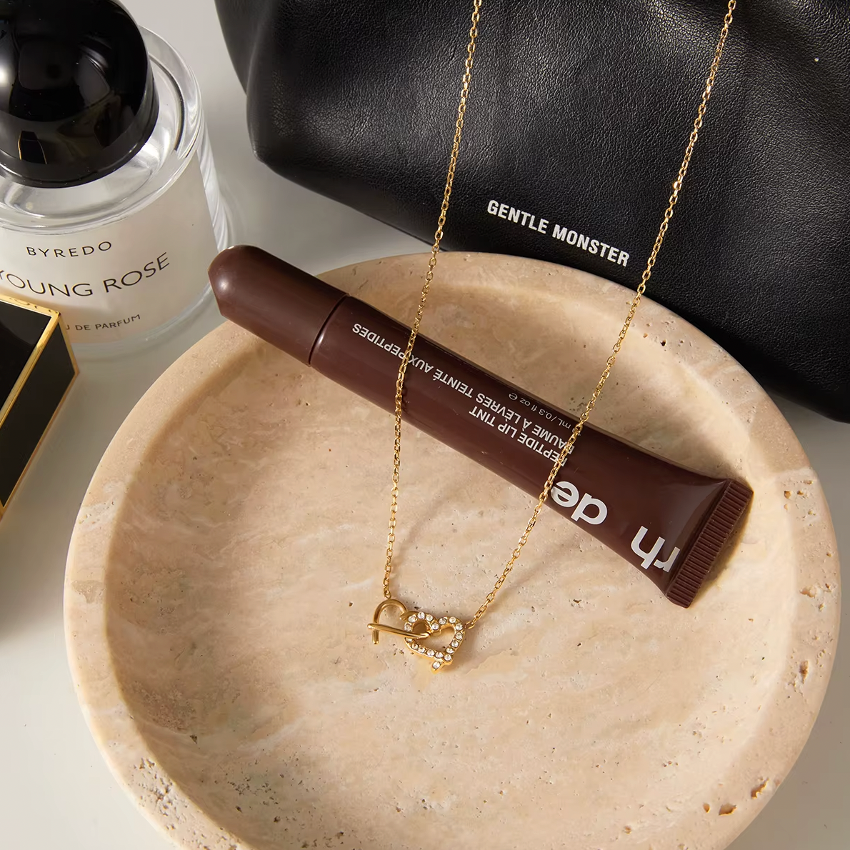 Gold-plated necklace with a delicate chain and interlocking heart-shaped pendant embellished with clear crystals