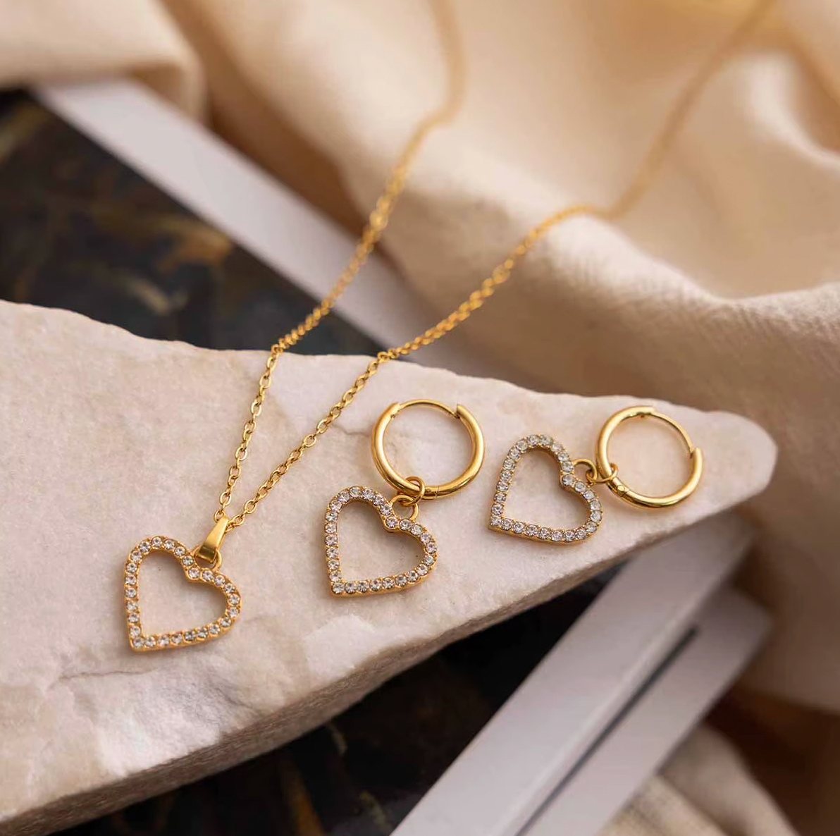 Gold-plated necklace with a delicate chain and an open heart pendant outlined with clear crystal stones