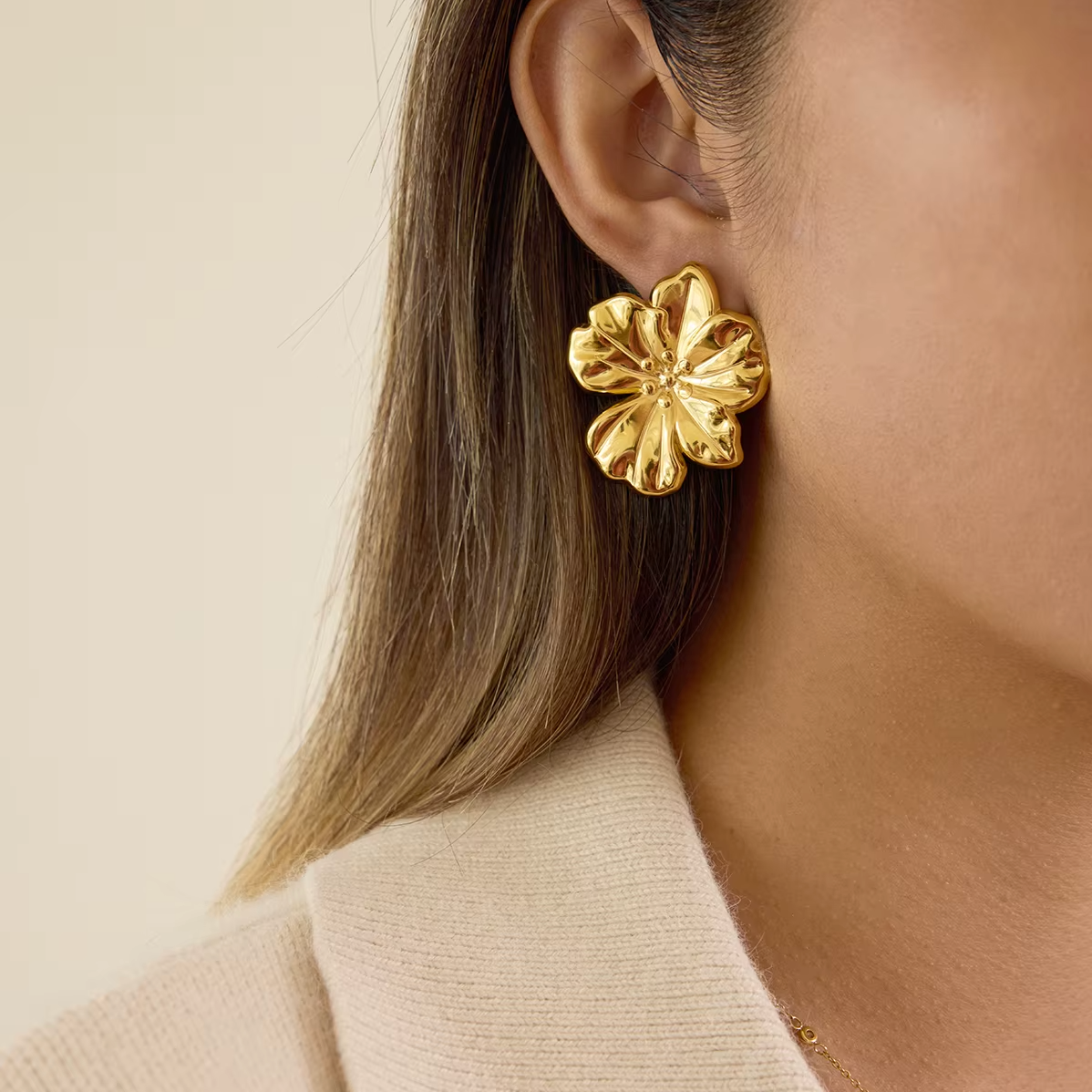 Gold-plated flower-shaped stud earrings with sculpted petals and a polished finish