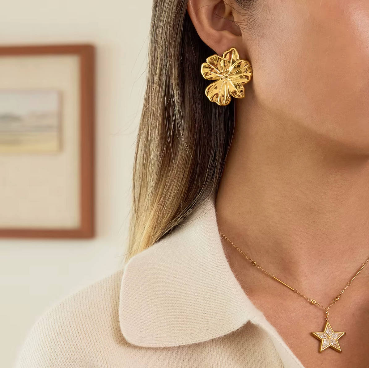 Gold-plated flower-shaped stud earrings with sculpted petals and a polished finish