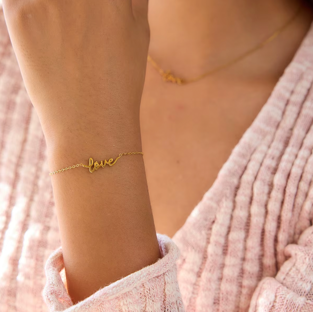 Gold-plated bracelet with a delicate chain and “love” script charm