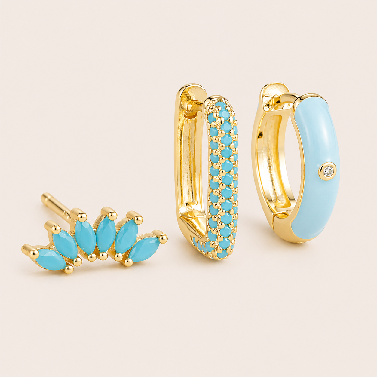 Three-piece Ames SET gold earrings in turquoise: a marquise ear climber, a pave hoop, and a turquoise enamel hoop with a stone accent.