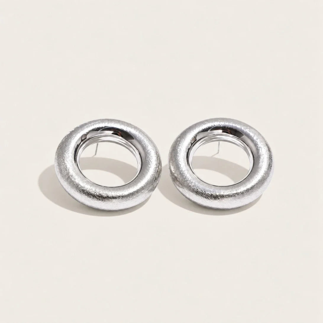 Silver-tone Anello EARRINGS: a pair of bold, rounded ring-shaped earrings with a textured surface — Folie à Trois