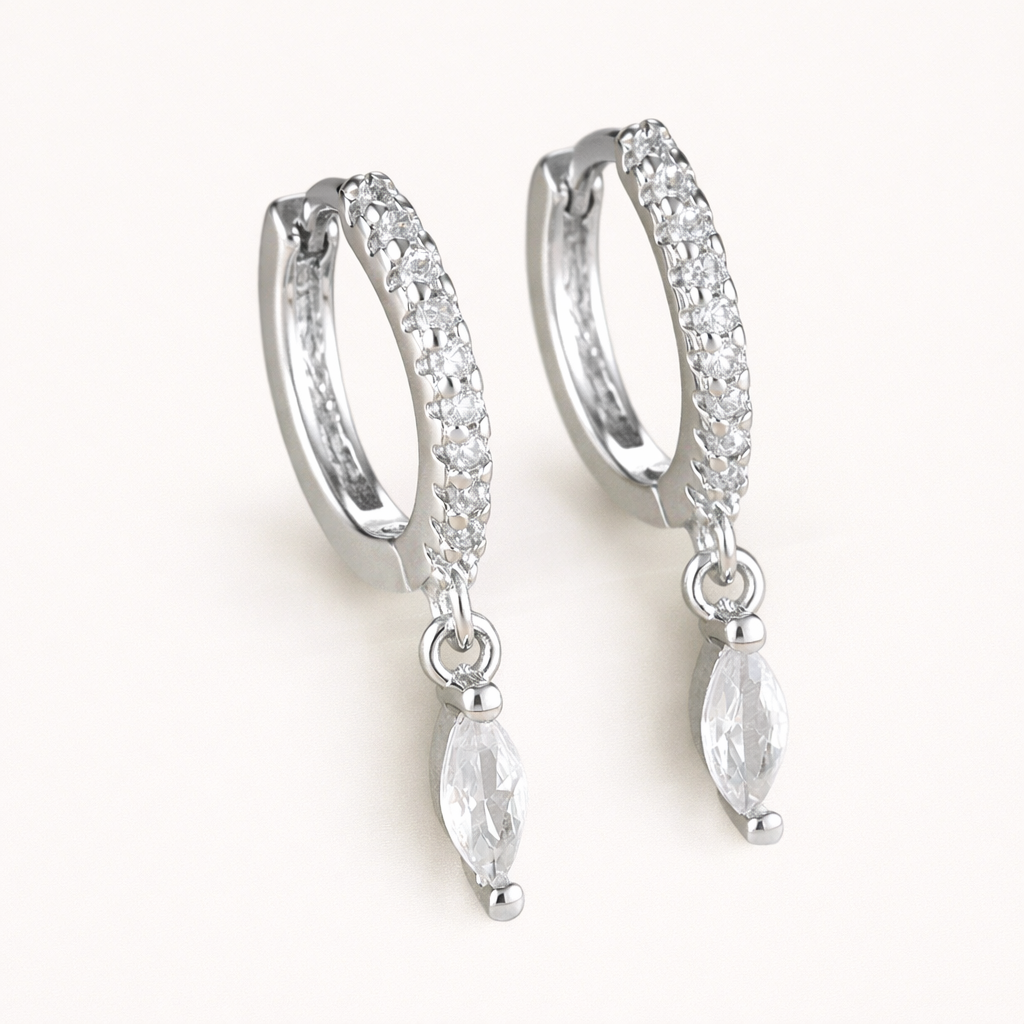 Anette Earrings in silver with clear crystals, showing the pave hoop and marquise crystal drop design.