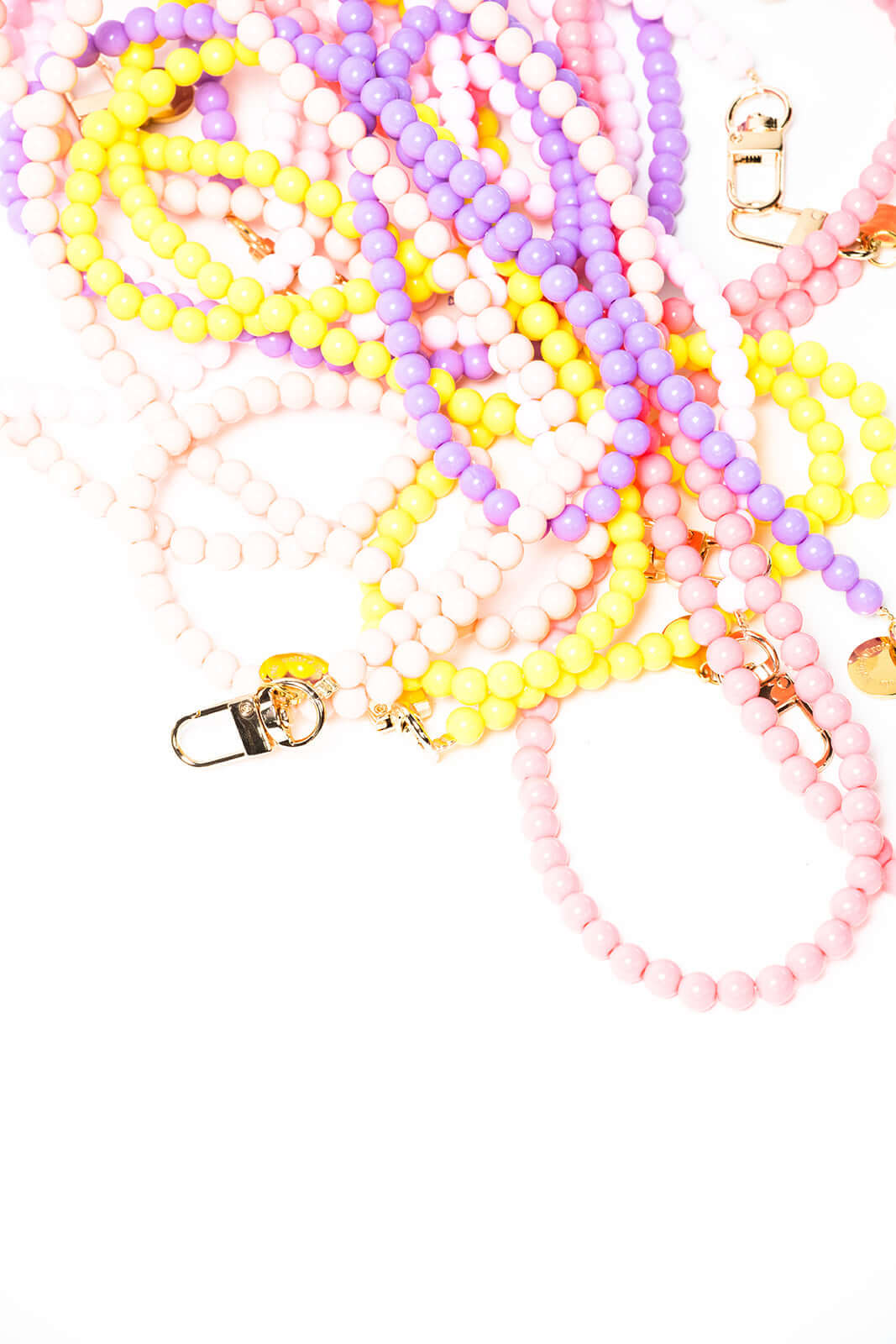 Another close-up angle of tangled pink, yellow, lavender and white beaded Aurora PHONE CORD strands.