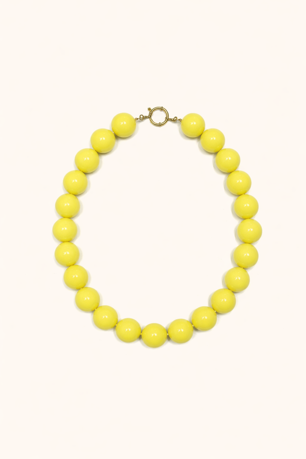 The Blaire NECKLACE in yellow, a single strand of large glossy round beads with a gold ring clasp, shown flat.