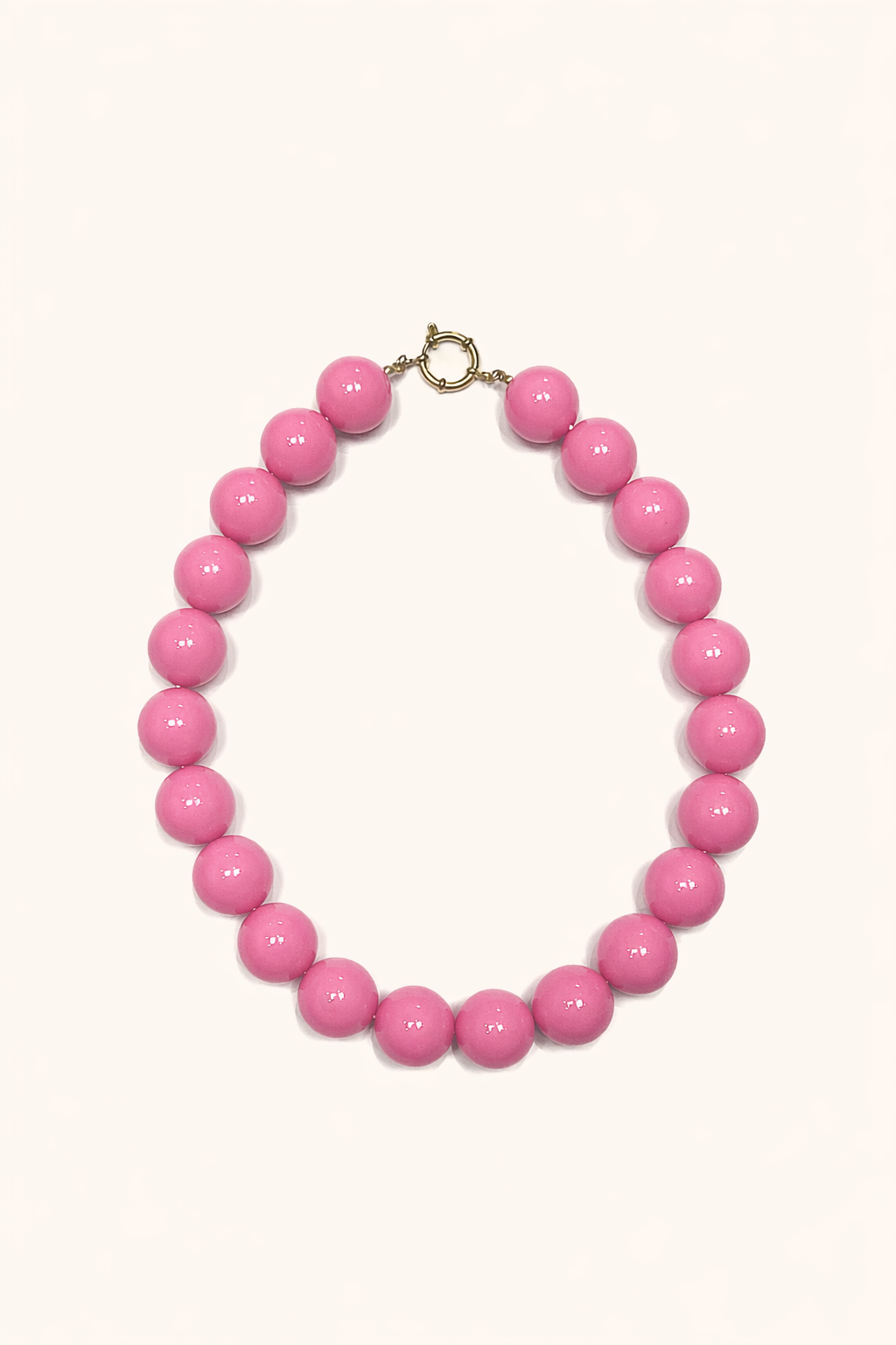 The Blaire NECKLACE in rose pink, a single strand of large glossy round beads with a gold ring clasp, shown flat.