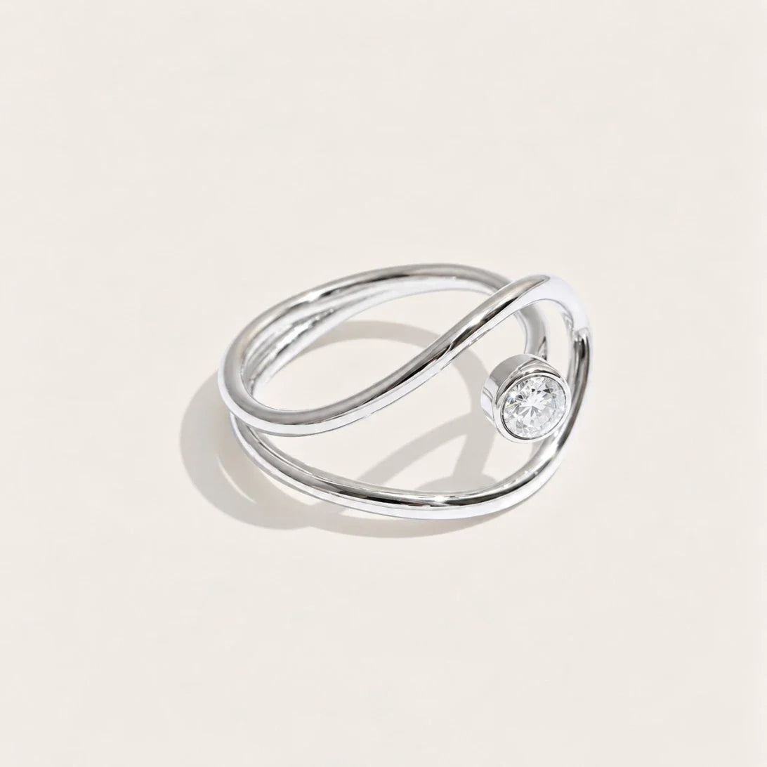 Silver-tone Cercle RING: a slim band looping into an open circle that frames a white zirconia stone — Folie à Trois