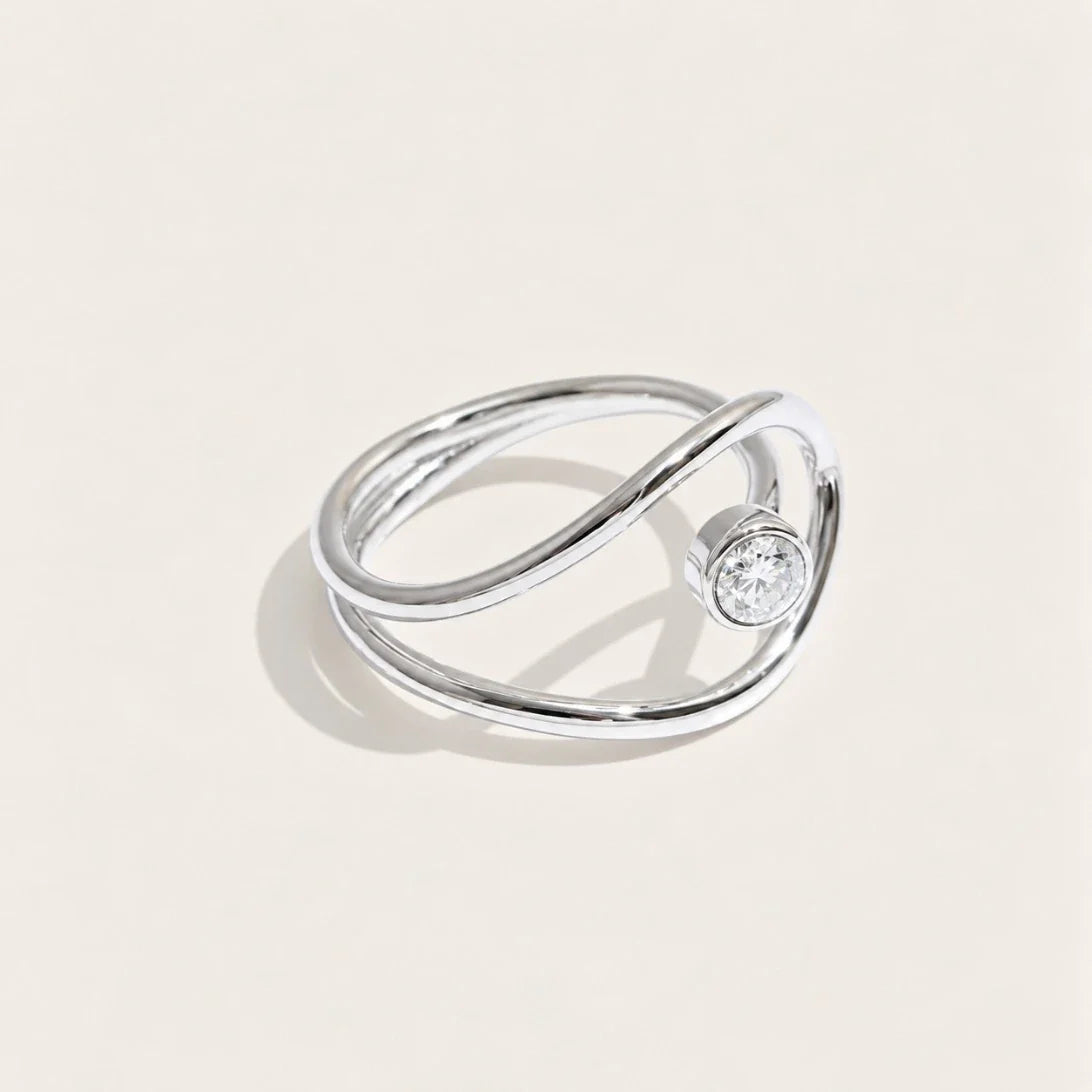 Silver-tone Cercle RING: a slim band looping into an open circle that frames a white zirconia stone — Folie à Trois