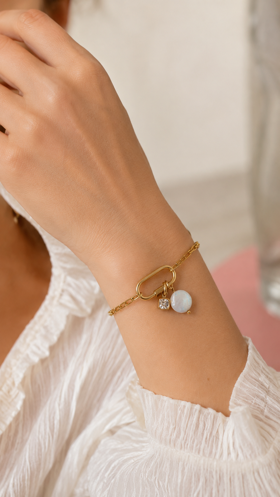 Chain link Charm BRACELET worn on the wrist with a pearl and crystal charm dangling from the carabiner clasp.