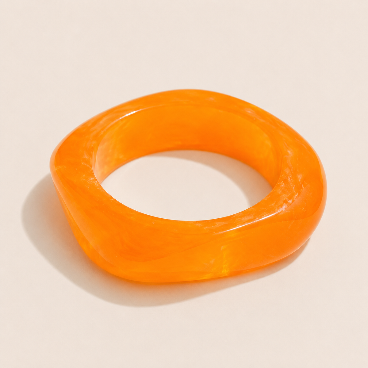 Coastal Escape BRACELET in orange marbled resin, a chunky angular bangle shown alone on a cream background.