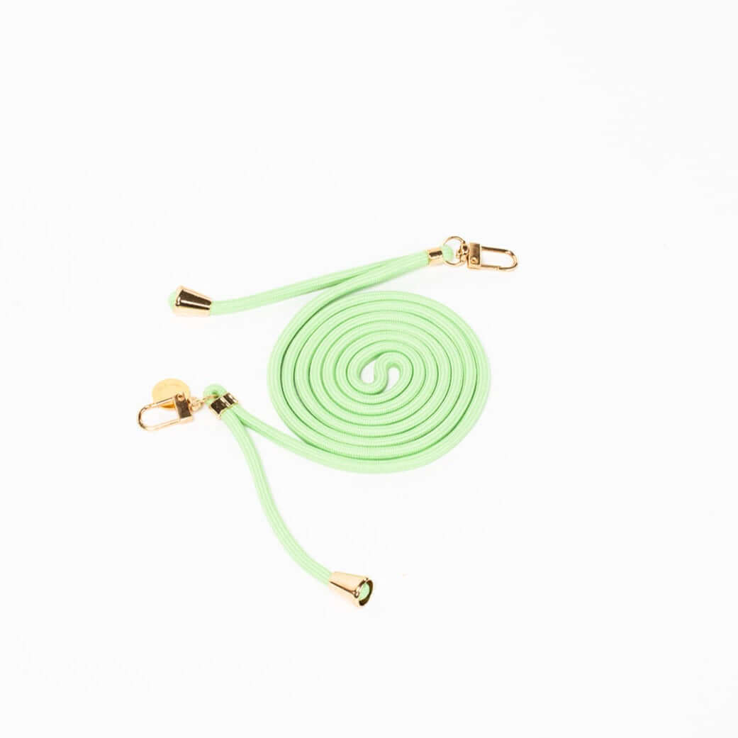 Mint green Colorful PHONE CORD coiled with gold-tone hardware on a white background.