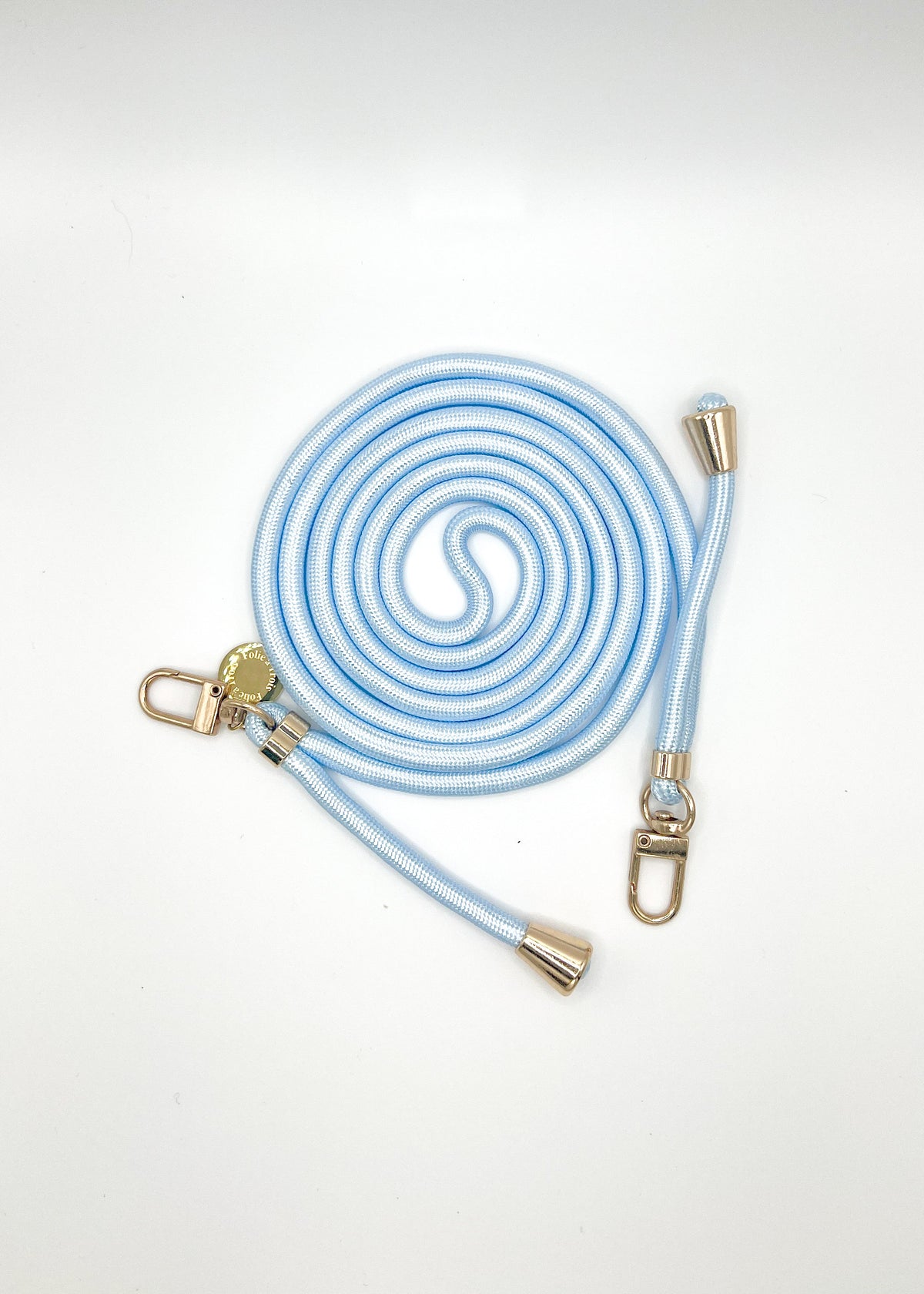 Pale blue and white Colorful PHONE CORD coiled with gold-tone hardware on a white background.