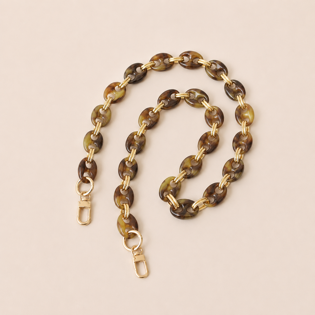 Olive brown tortoiseshell coin-link phone chain with gold connectors coiled on cream — Folie à Trois Corvin long phone chain