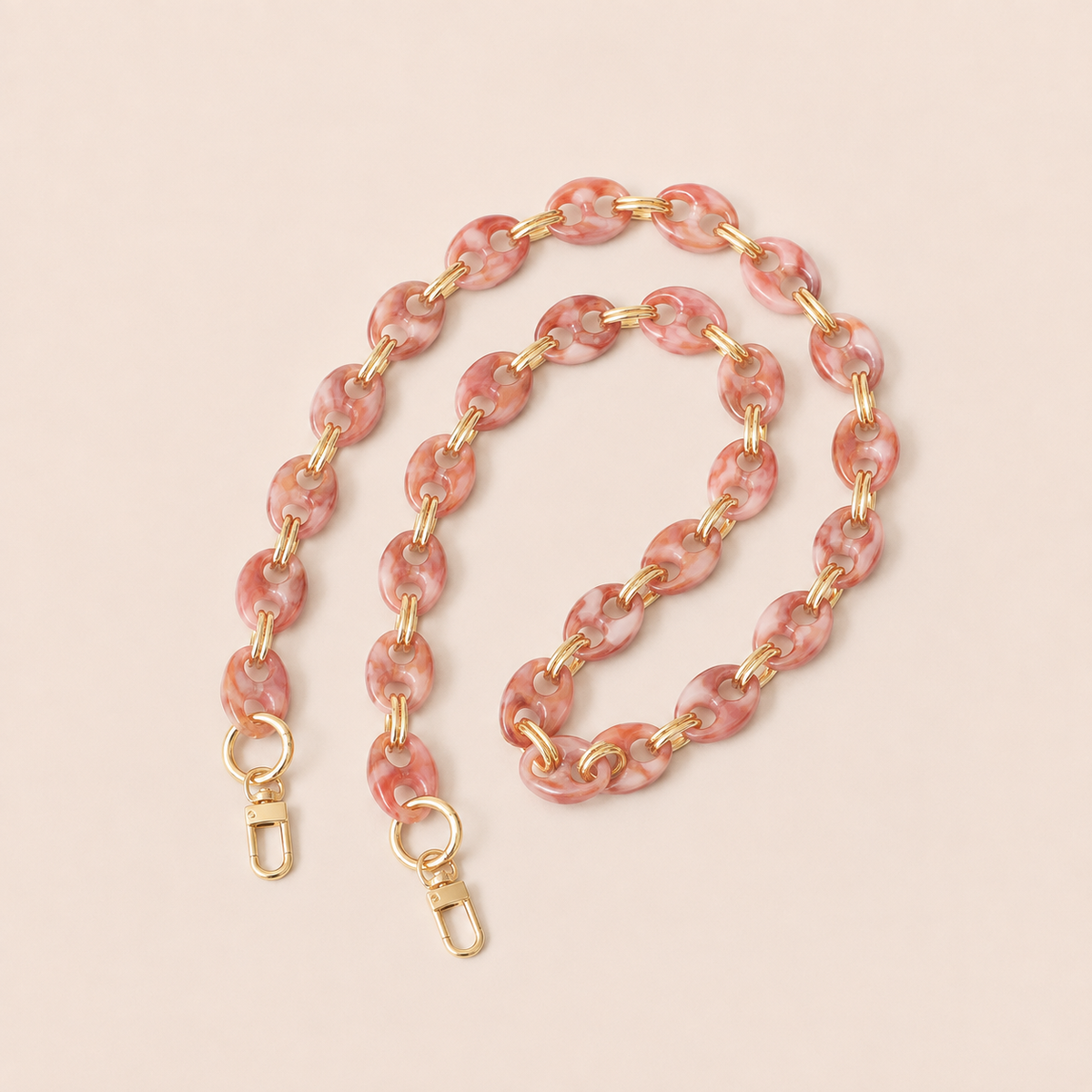 Pink marbled coin-link phone chain with gold connectors coiled on cream — Folie à Trois Corvin long phone chain