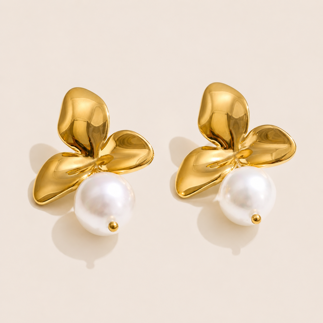 Gold orchid petal stud earring with a glossy white pearl drop beneath the flower — Folie à Trois Côte d'Or EARRINGS.