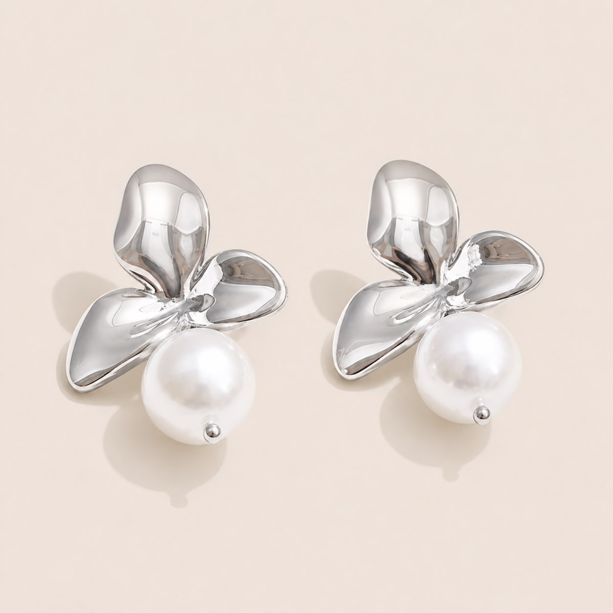 Silver orchid petal stud earring with a glossy white pearl drop beneath the flower — Folie à Trois Côte d'Or EARRINGS.