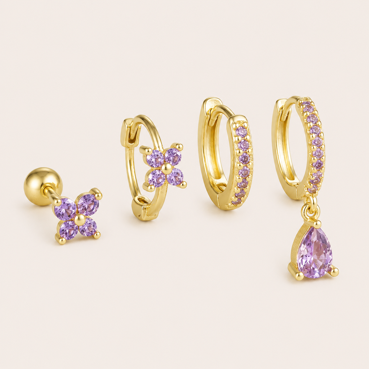 Four-piece Deanna SET gold earrings in purple: a flower stud, a flower hoop, a pave hoop, and a pave hoop with a pear-cut drop charm.
