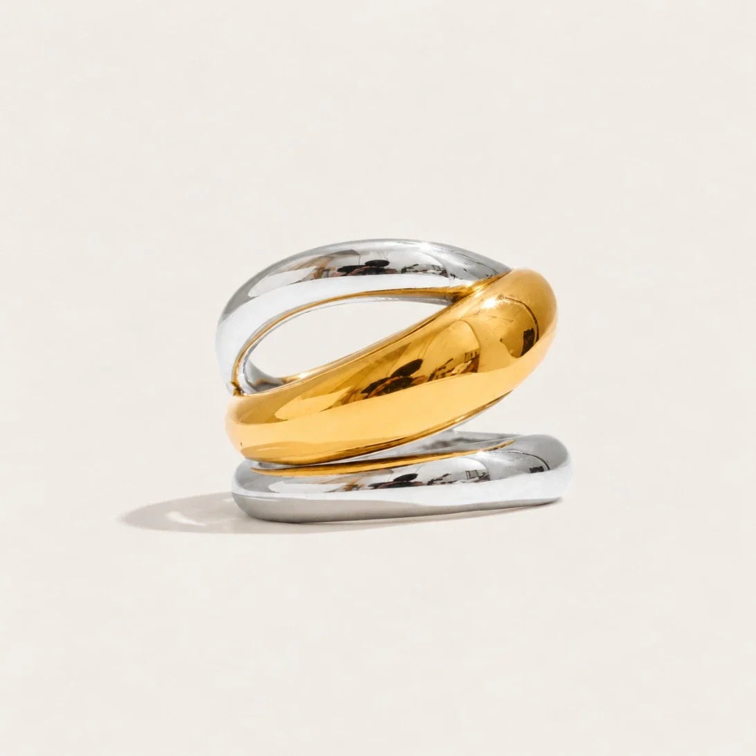 Two-tone Duetto RING: a hollow spiral band with a gold-tone wrap curling over a silver-tone base — Folie à Trois