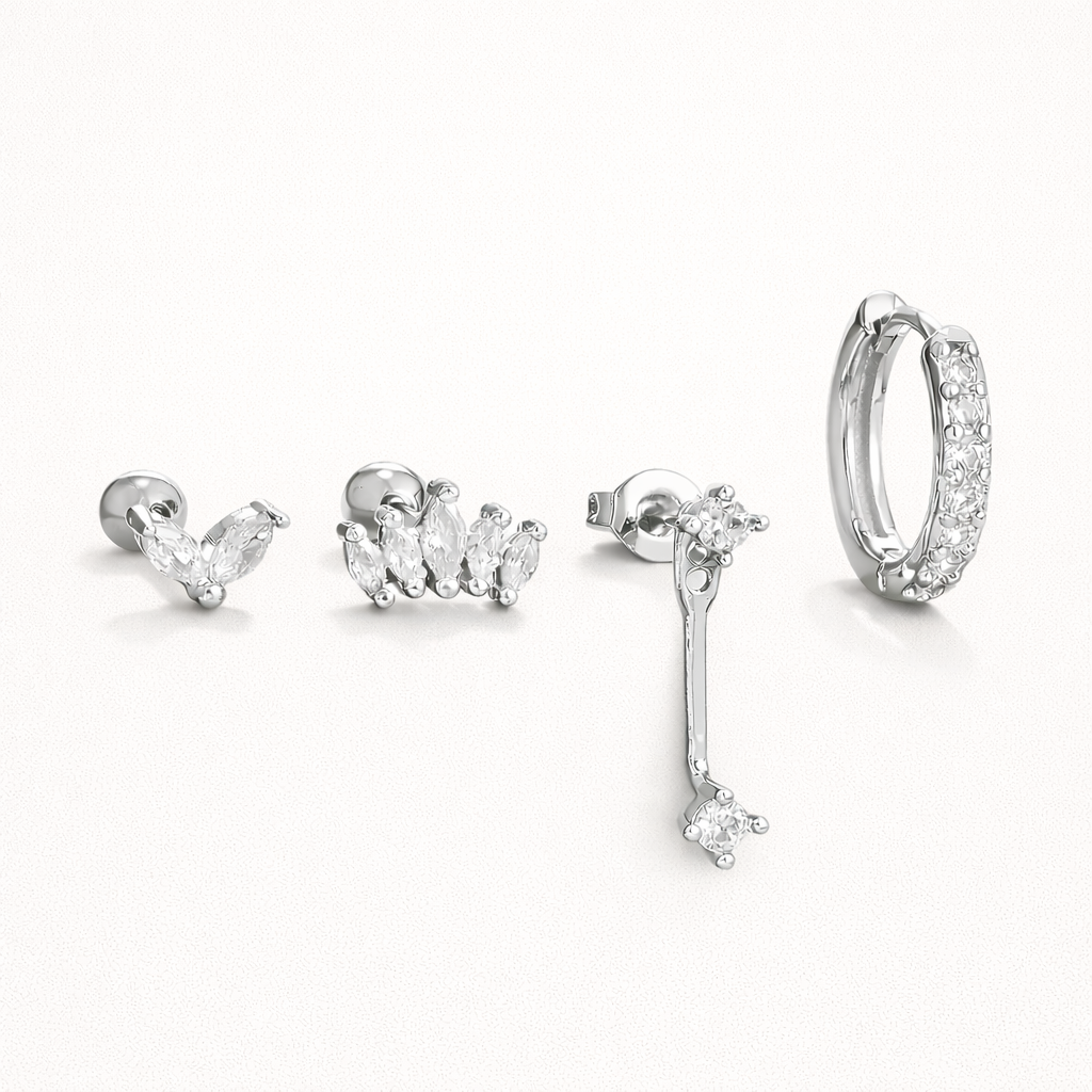Elodie Set in silver tone, showing the same marquise cluster stud, crown stud, crystal drop, and pave huggie hoop pieces.