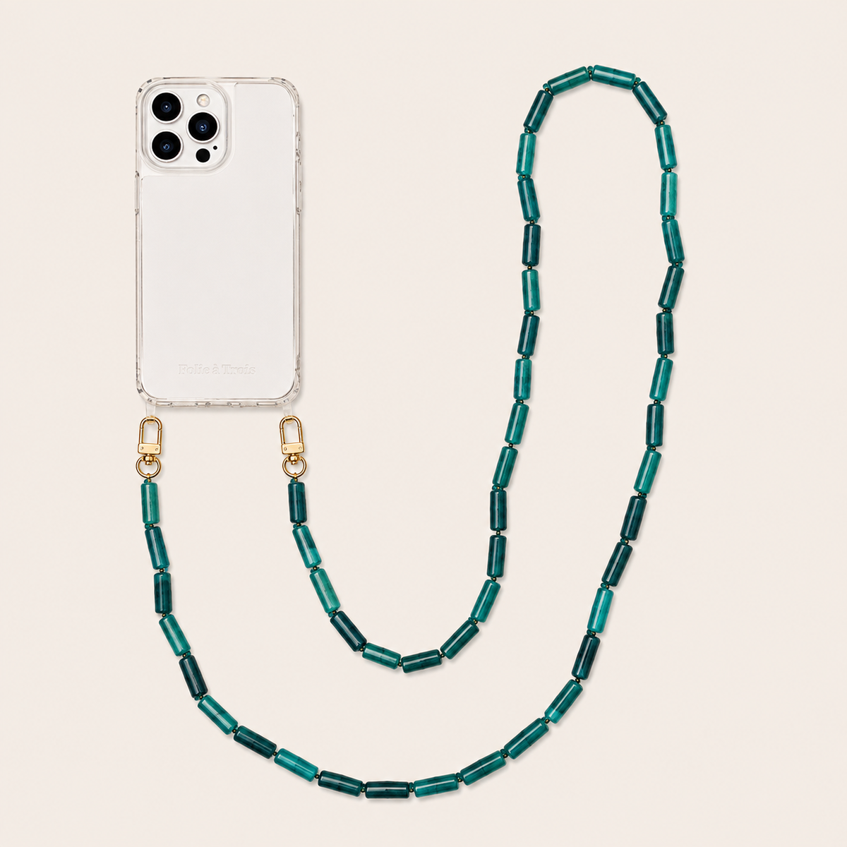 Teal tube-bead phone chain clipped to a clear iPhone case on a cream background — Folie à Trois Elowen wholesale phone chain