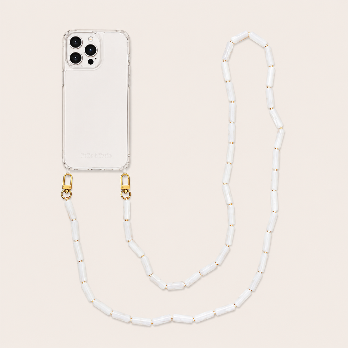 White pearl tube-bead phone chain clipped to a clear iPhone case on a cream background — Folie à Trois Elowen wholesale phone chain