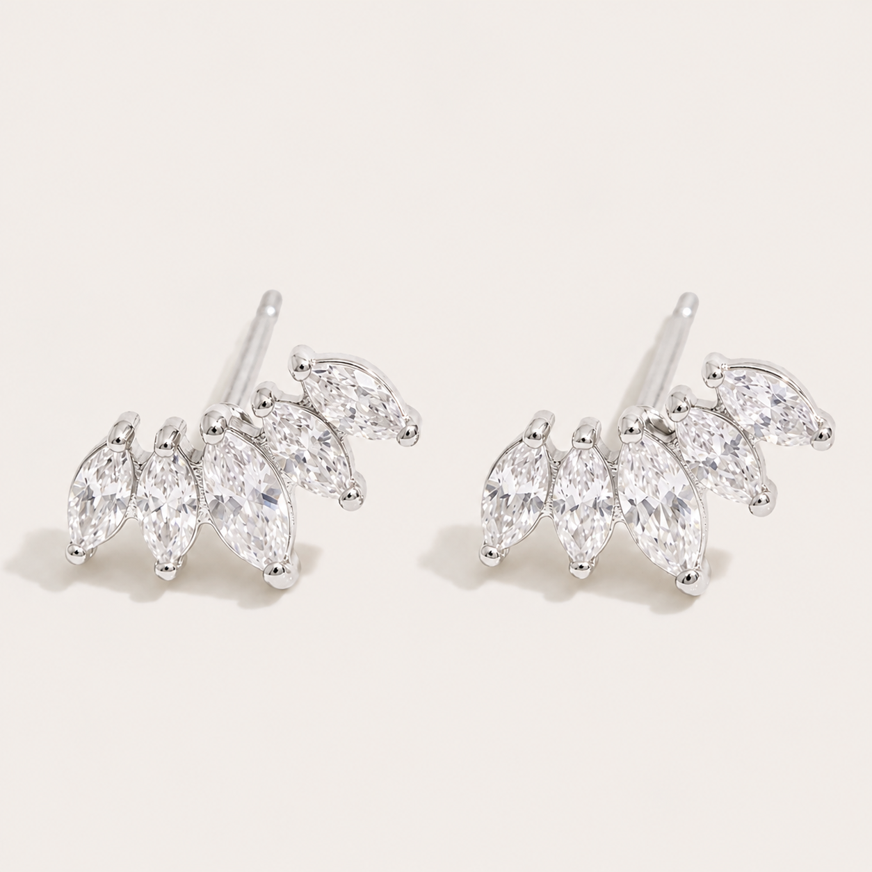 Silver marquise-cut zirconia climber studs fanned in a cluster on a cream backdrop — Folie à Trois Facet EARRINGS