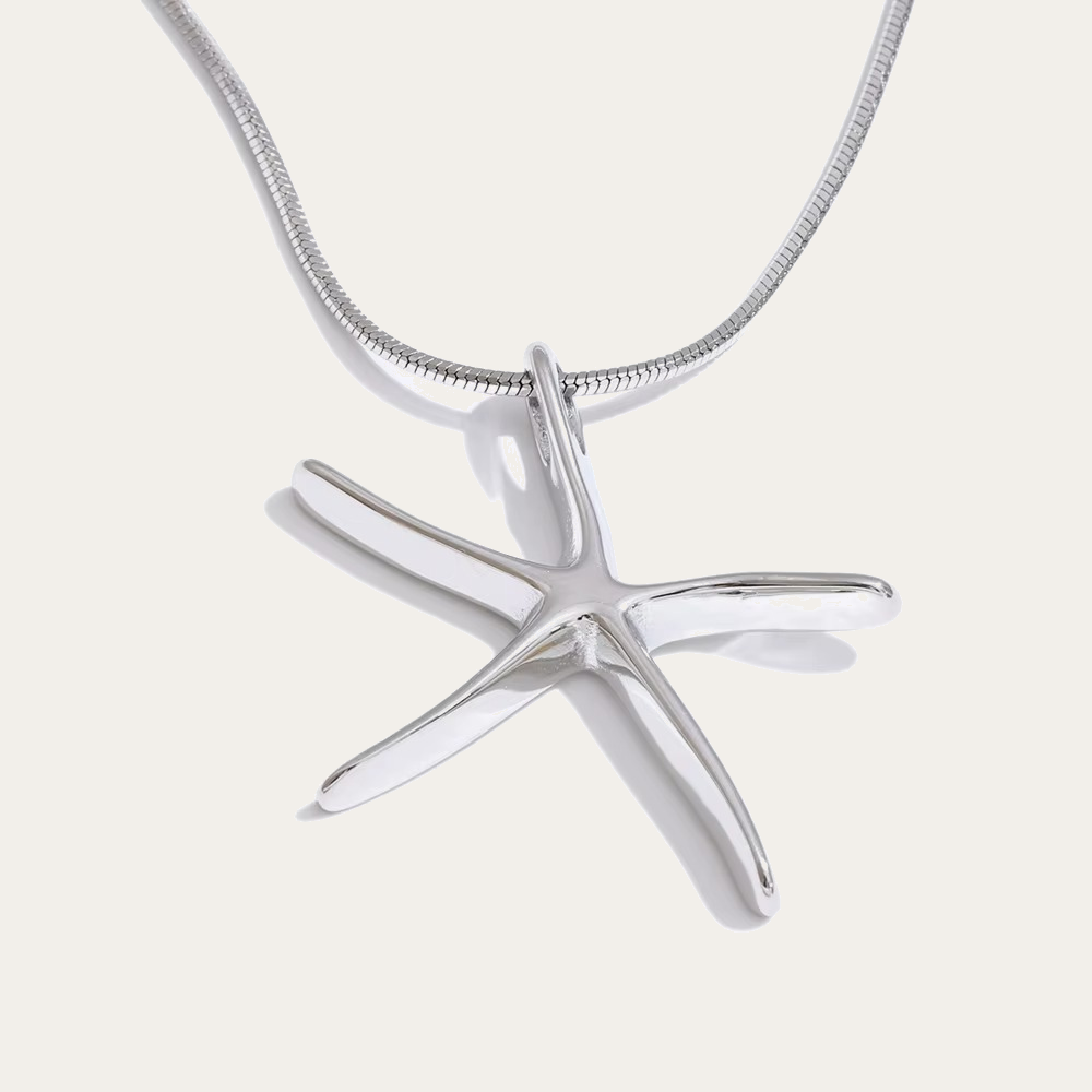 The Fiji NECKLACE in silver, its sculptural starfish pendant shown alone on a fine snake chain against a plain studio background.