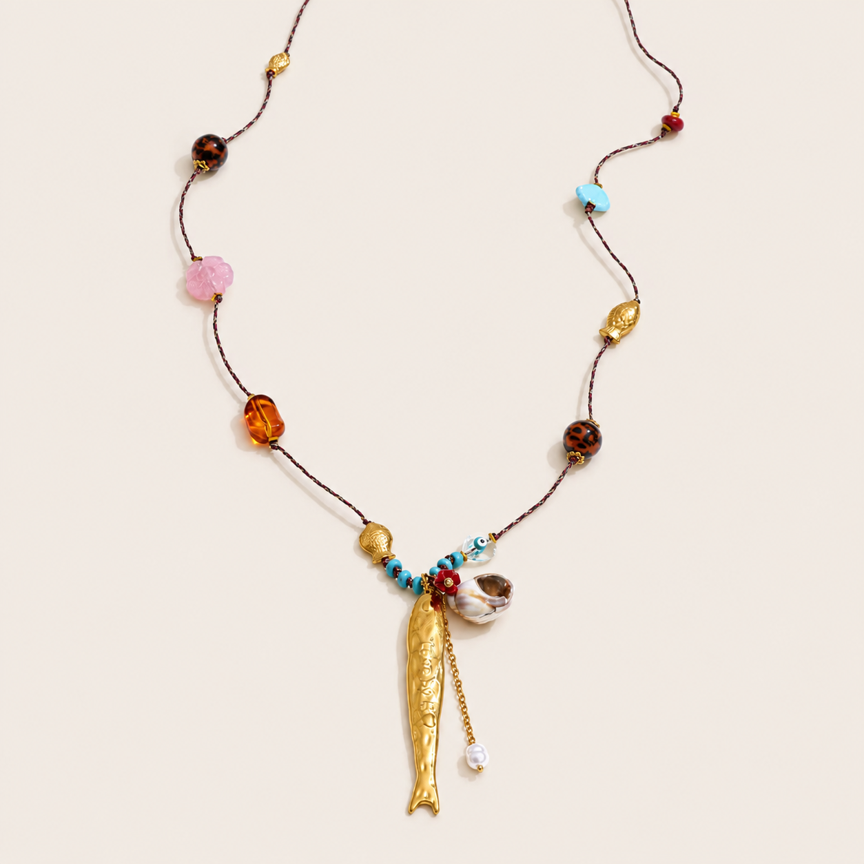 French Summer NECKLACE with mixed beads in amber, pink, tortoiseshell and turquoise, and a gold fish charm pendant.