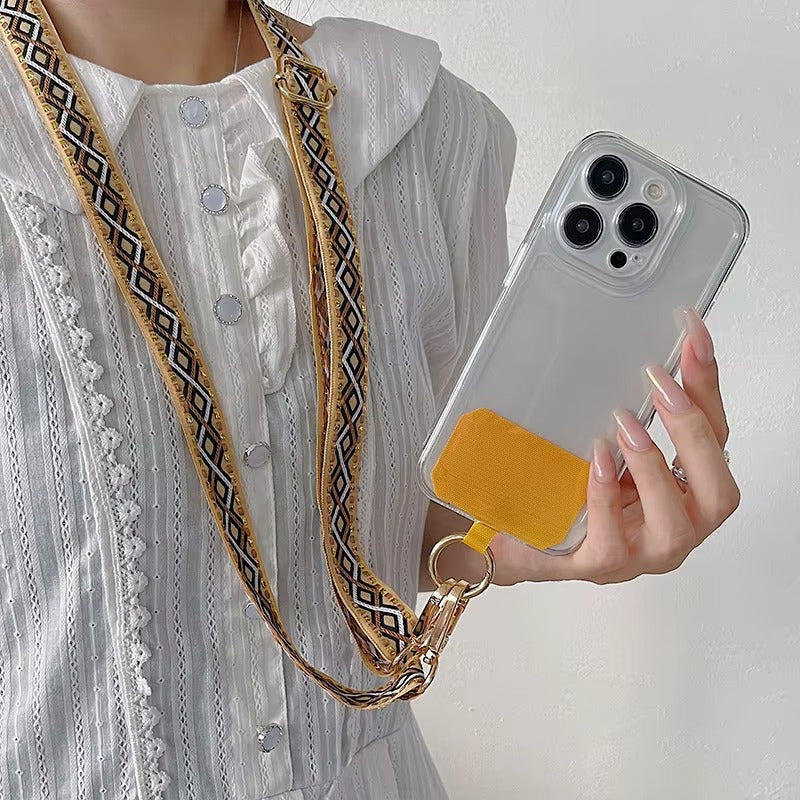Model wears the tan and navy woven Getaway strap crossbody, holding a phone with a mustard case.