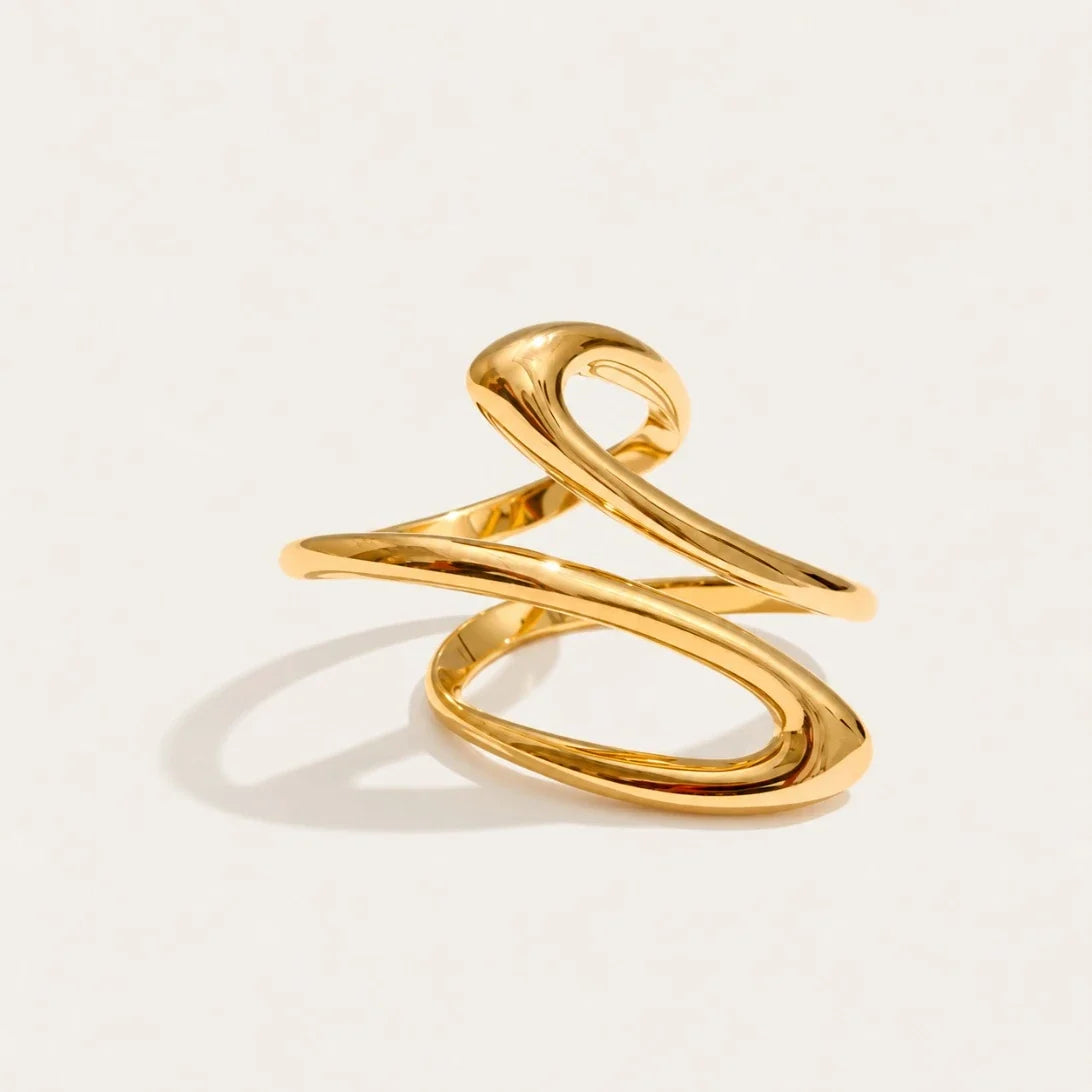 Gold Infini RING: a slim open wire ring crossing over itself in a figure-eight spiral — Folie à Trois