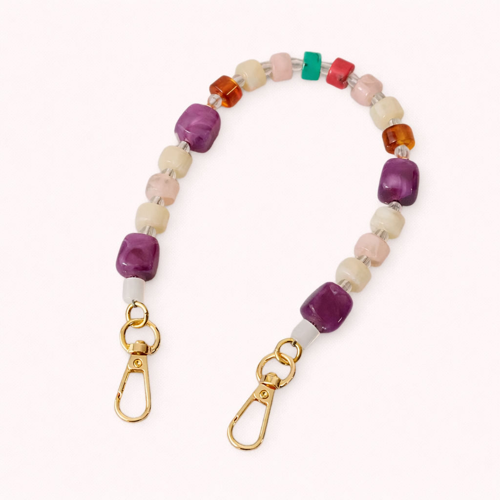 The Jaqueline SHORT PHONE STRAP in purple, cream, dusty pink, teal, and amber beads finished with gold-tone lobster clasps.