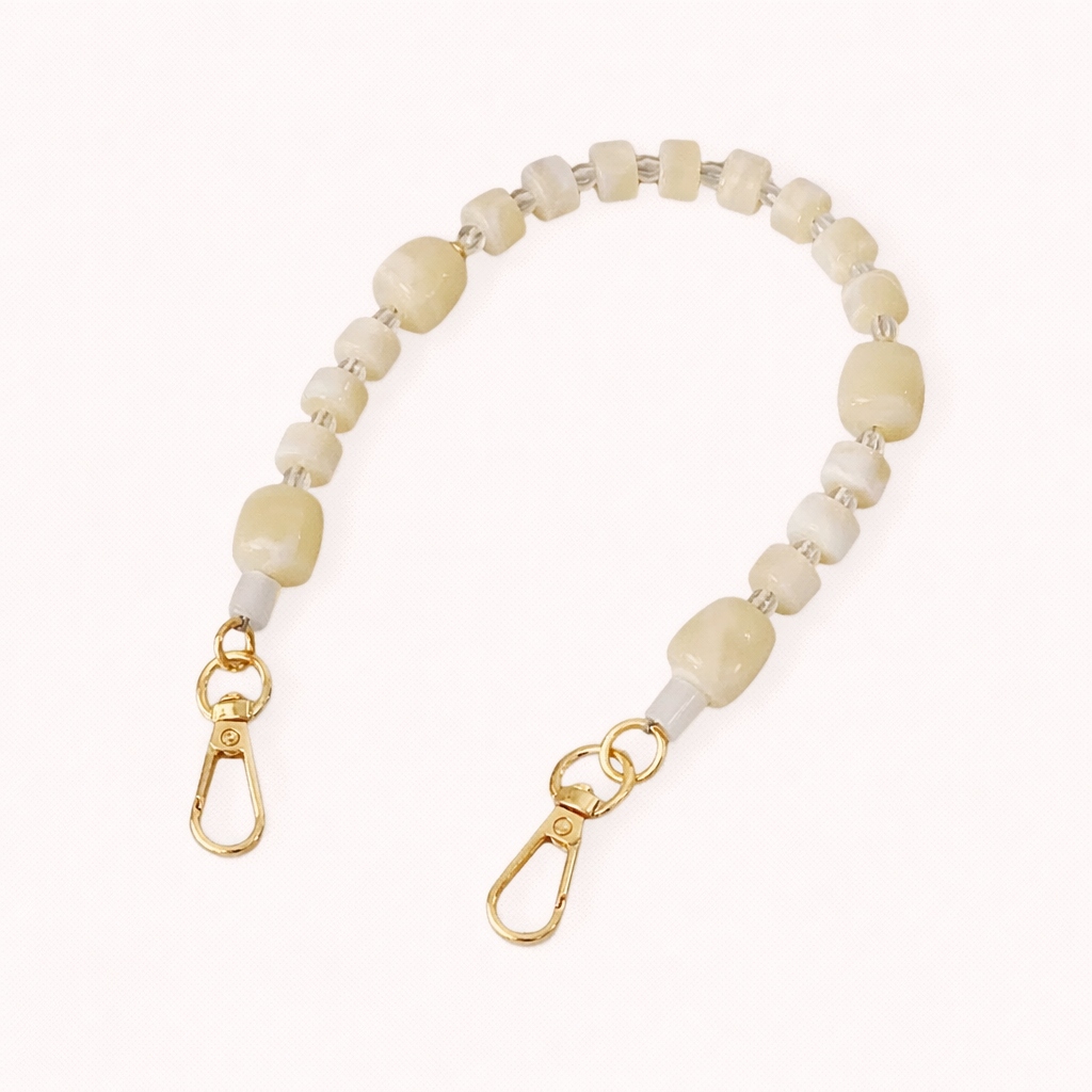 The Jaqueline PHONE STRAP in a chunky gold-tone oval link chain, shown in four matching lengths with lobster clasp ends.
