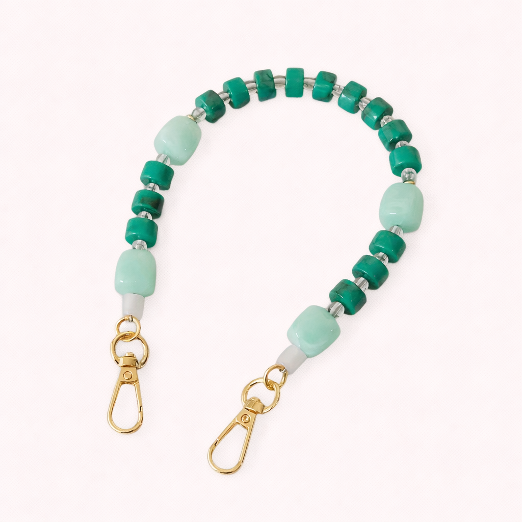 The Jaqueline PHONE STRAP in a pale yellow chunky acrylic link chain with gold-tone hardware and clasps at both ends.