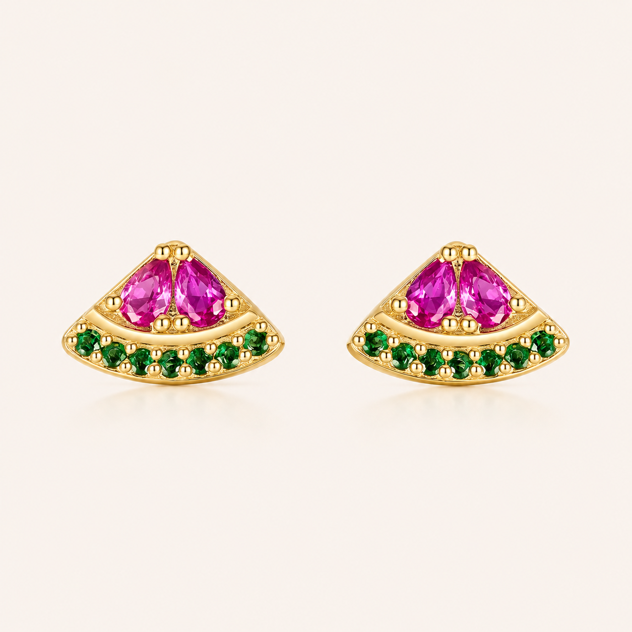 Gold fan-shaped stud earrings from the Little Fruit EARRINGS with two pink stones and a row of green stones, evoking a watermelon slice.