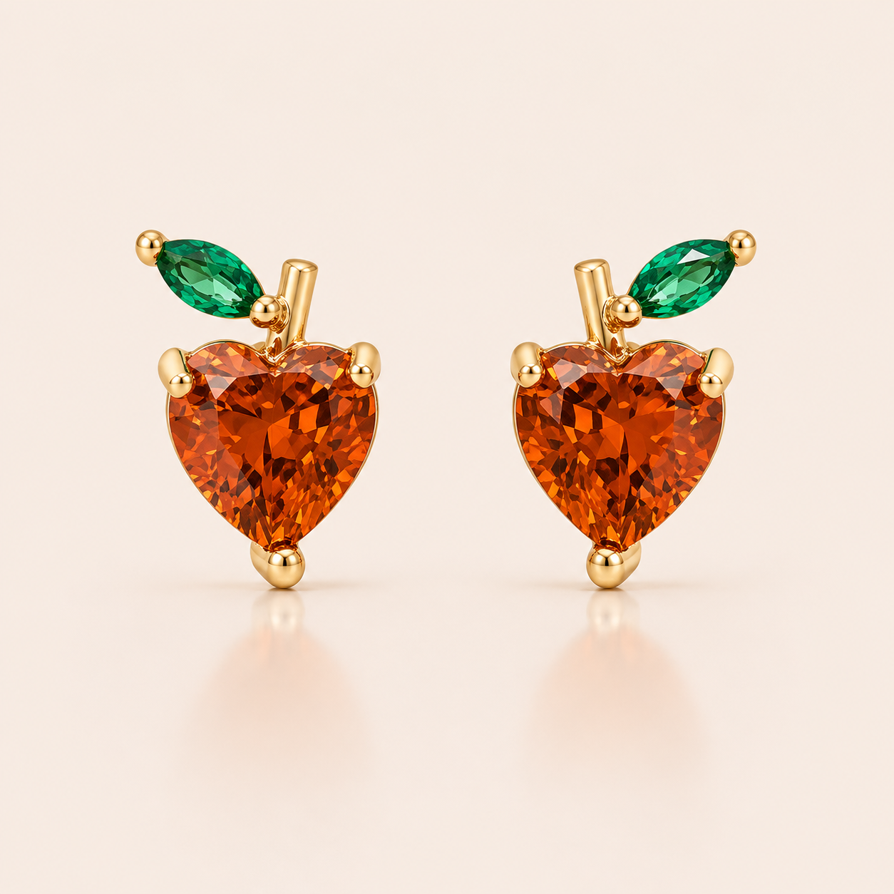 Gold apple-shaped stud earrings from the Little Fruit EARRINGS with an amber heart-cut cubic zirconia and a green marquise leaf.