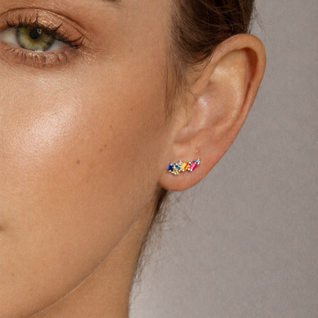 Worn along the ear, Ma Cherie Earrings trace the lobe with their scattered cluster of colorful baguette stones.