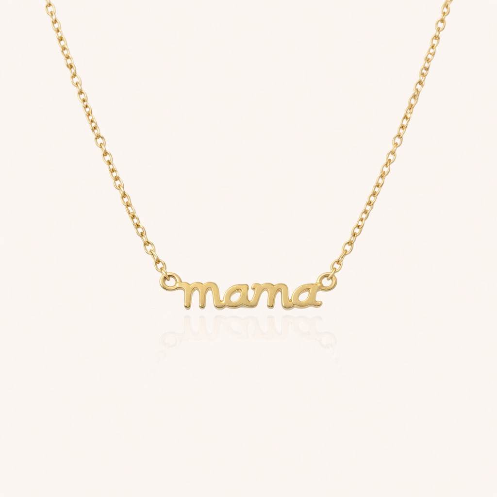 The Mama Small NECKLACE in gold, a delicate script mama pendant on a fine chain, shown flat on a cream background.