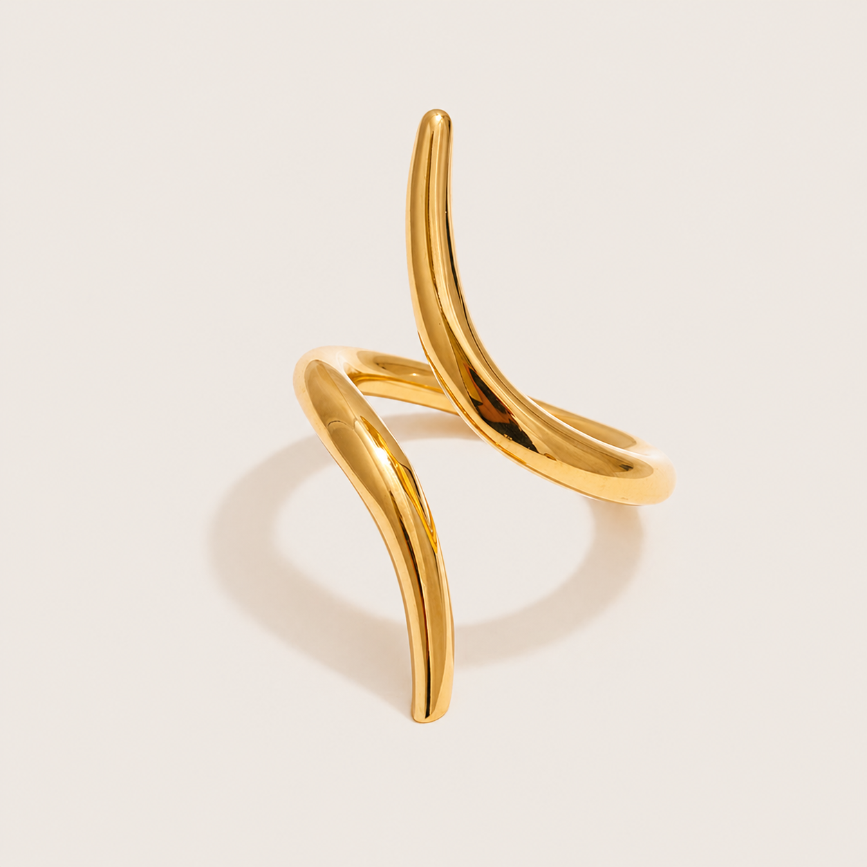 Gold ring with two curved, thorn-like open pieces crossing in an asymmetric sculptural shape — Folie à Trois Obsidian RING.