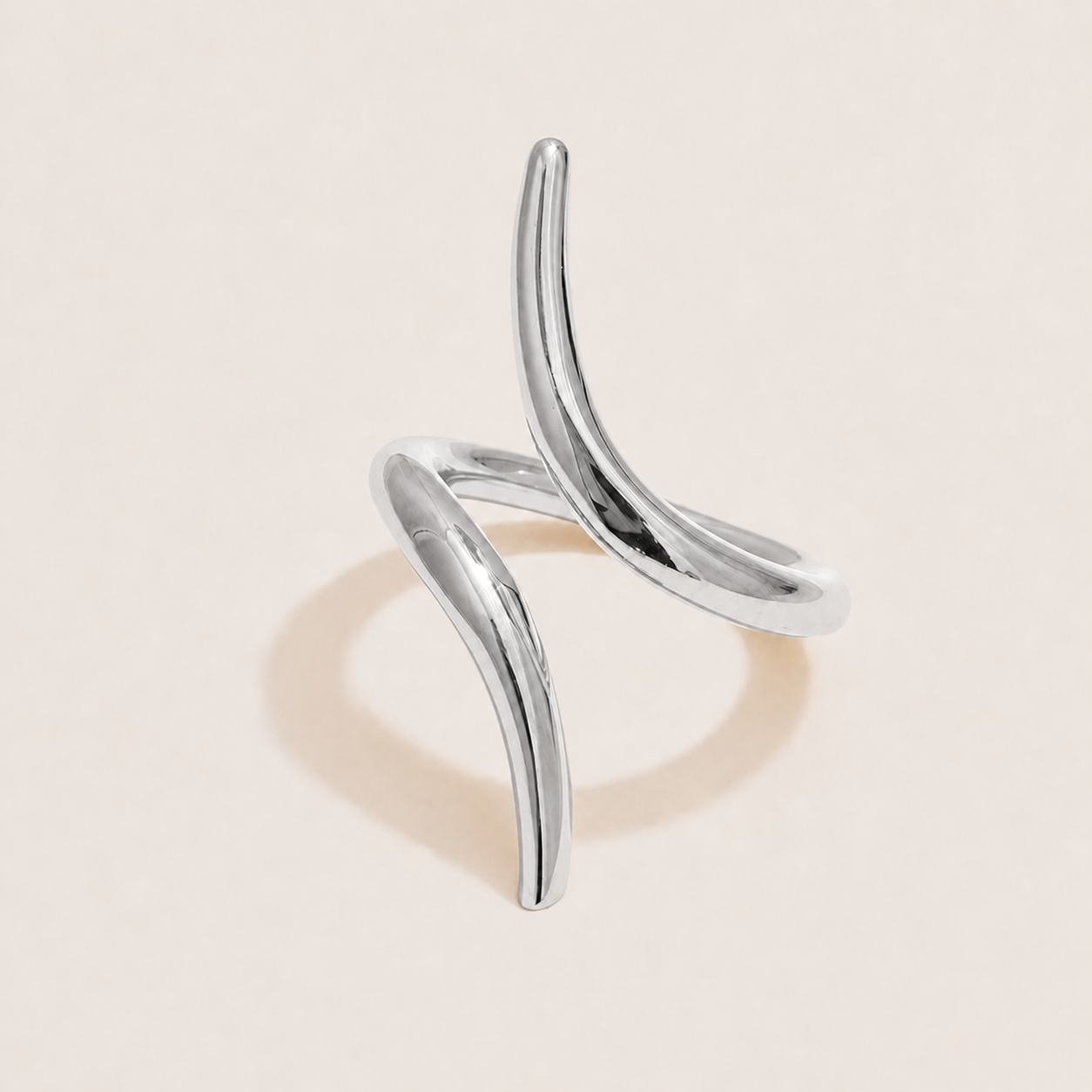 Silver ring with two curved, thorn-like open pieces crossing in an asymmetric sculptural shape — Folie à Trois Obsidian RING.