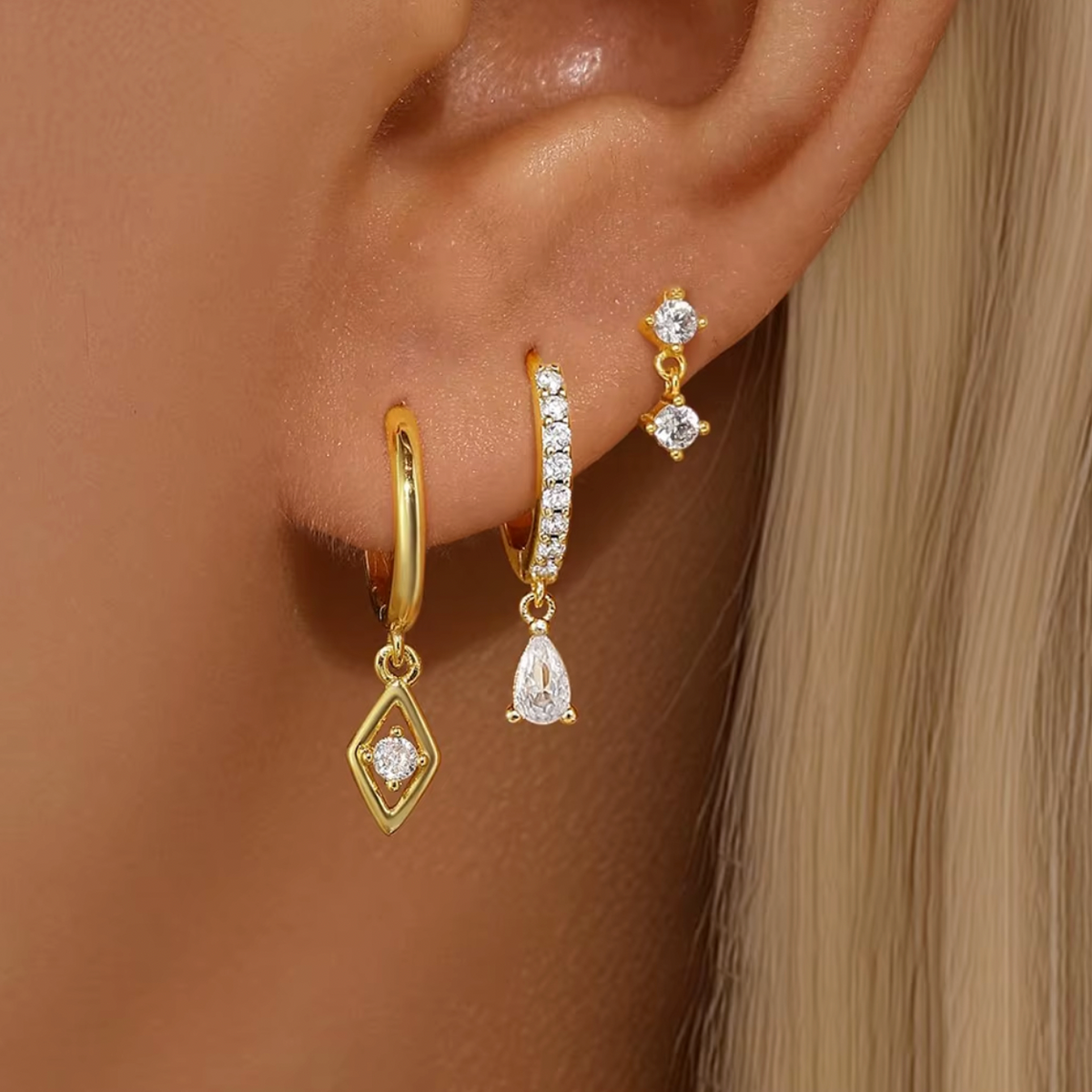 Worn along the ear, the Piper SET layers a crystal stud with two gold hoops trailing crystal drop charms.