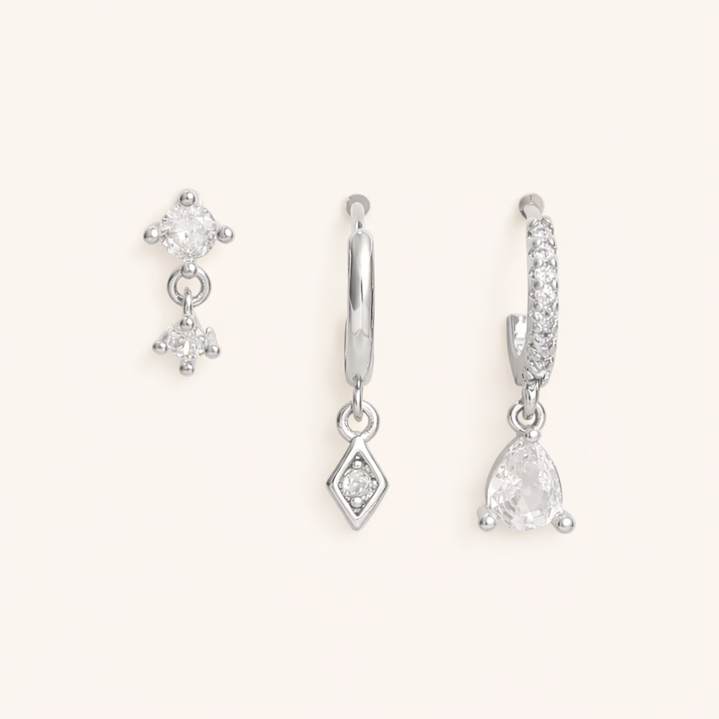 The Piper SET is shown in silver: a double-crystal drop stud, a diamond-drop hoop, and a pave teardrop hoop.