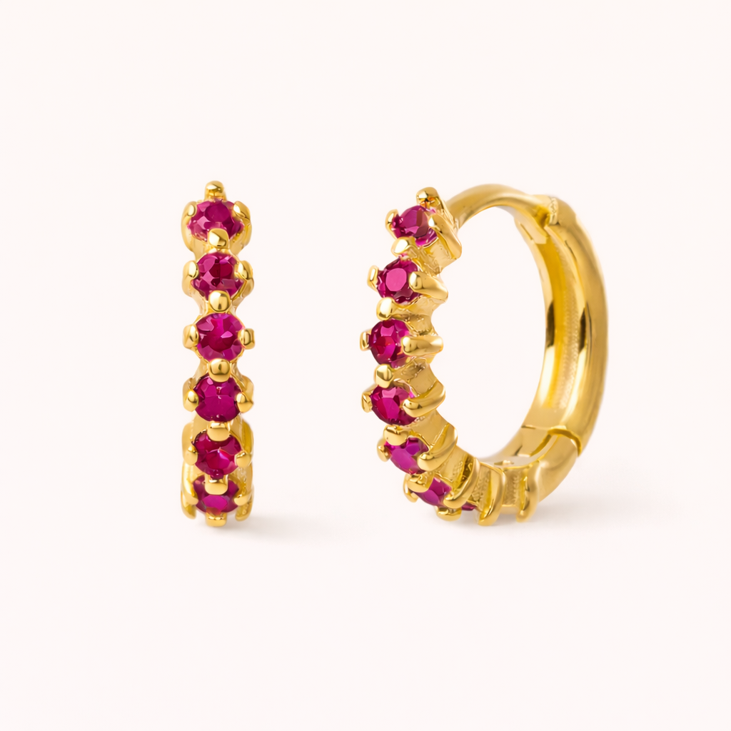 Retro Filter Earrings in gold with fuchsia-pink crystals, showing the five-stone graduated huggie hoop design.