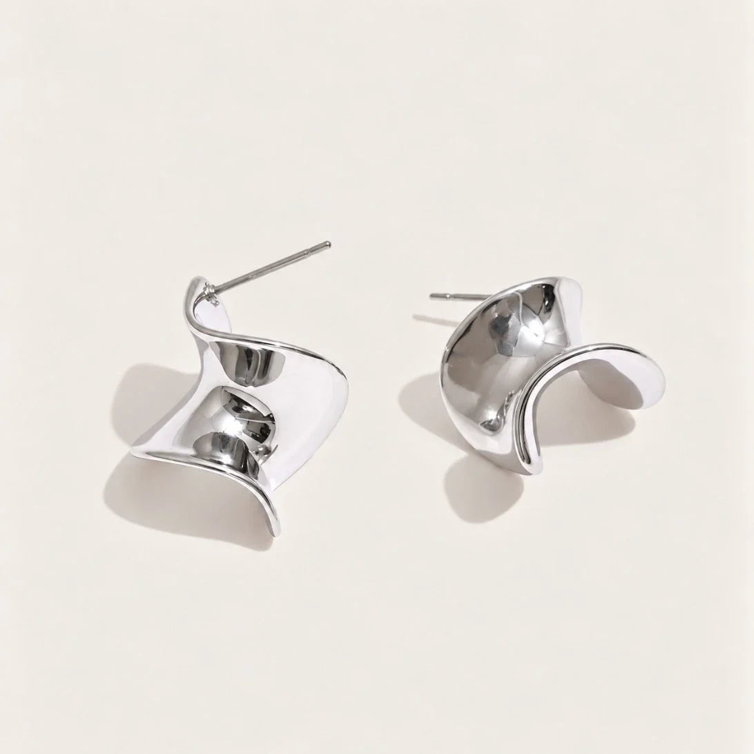 Silver-tone Ribbon EARRINGS: a pair of small studs shaped like a twisted, wavy ribbon bow — Folie à Trois
