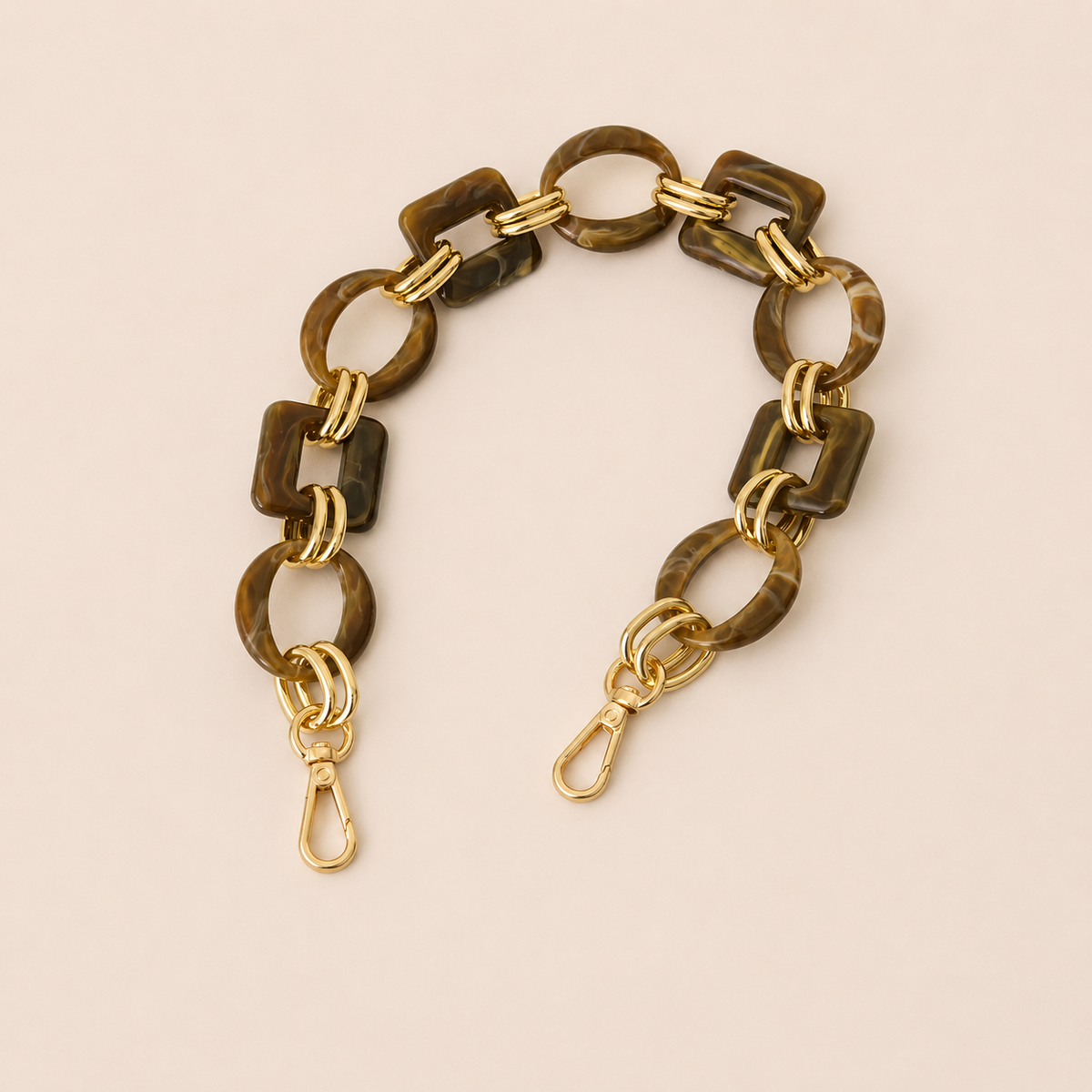 Short dark brown tortoiseshell acrylic link phone chain with gold connectors on cream — Folie à Trois Rowan short phone chain