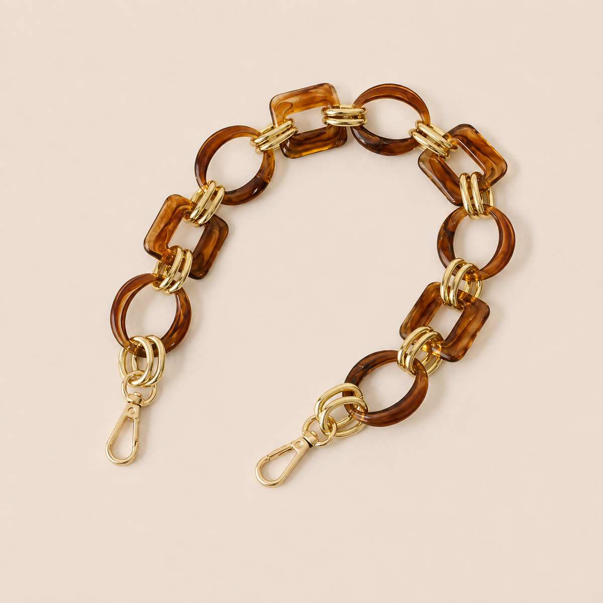 Short amber tortoiseshell acrylic link phone chain with gold connectors on cream — Folie à Trois Rowan short phone chain