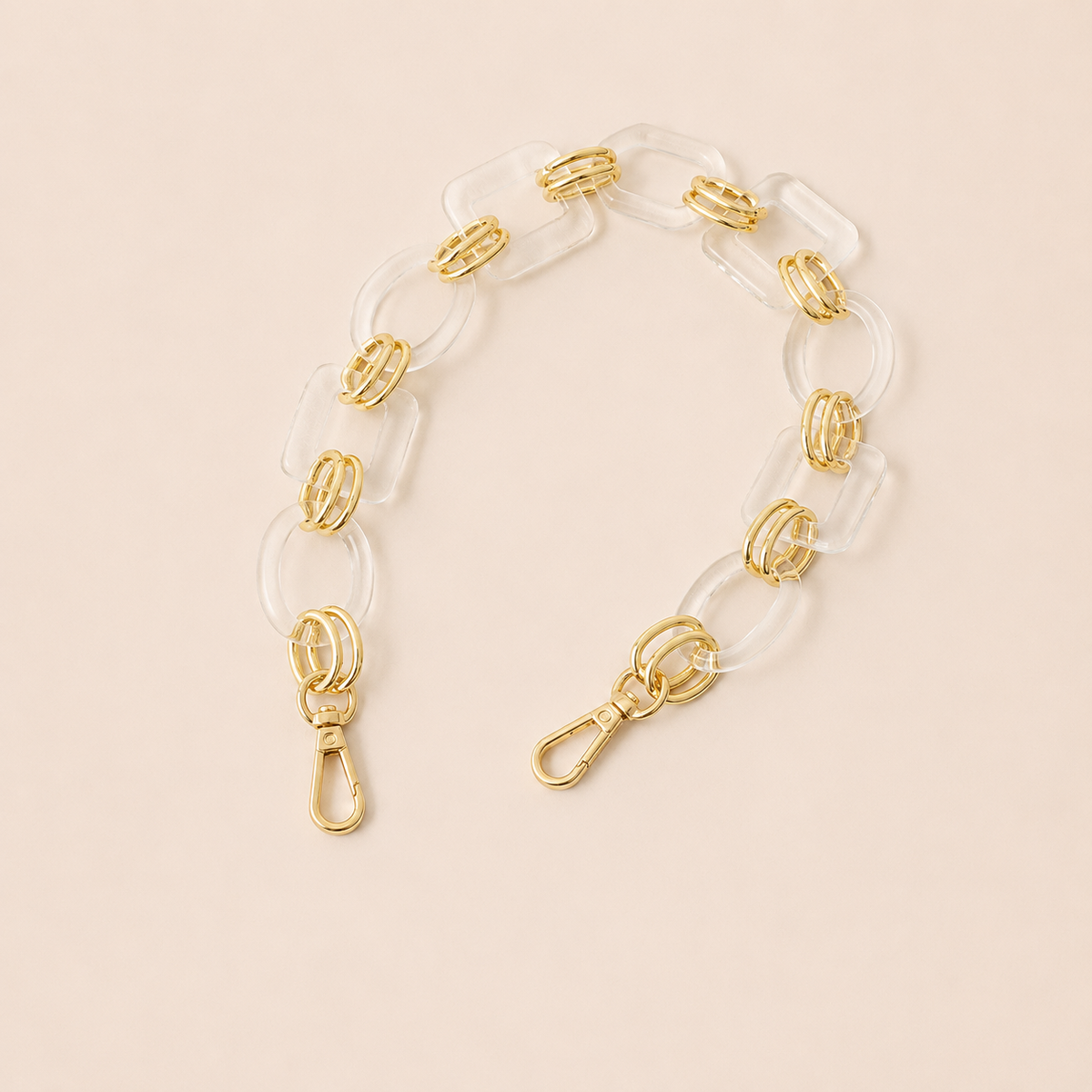 Short clear acrylic link phone chain with gold connectors on cream — Folie à Trois Rowan short phone chain