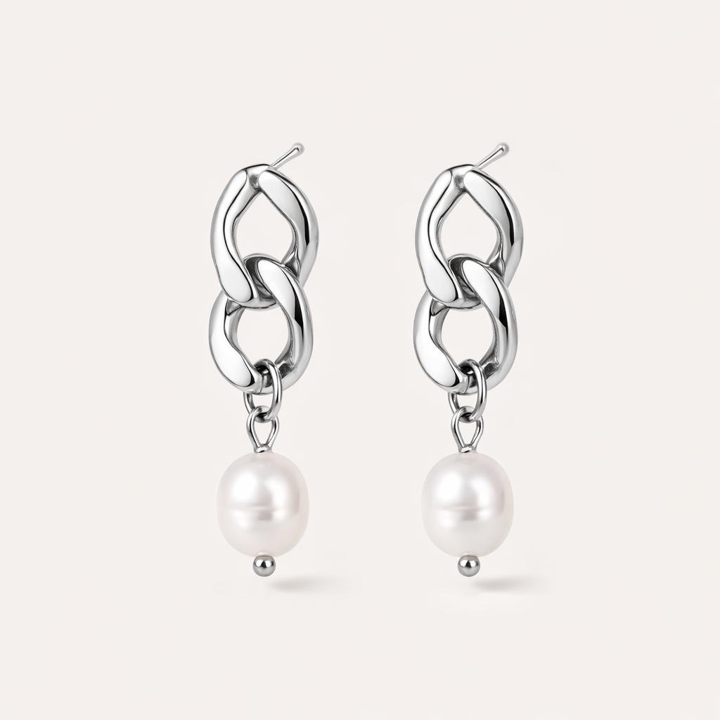 Rule Earrings link two chunky silver curb-chain loops that drop into a smooth freshwater pearl at the base.