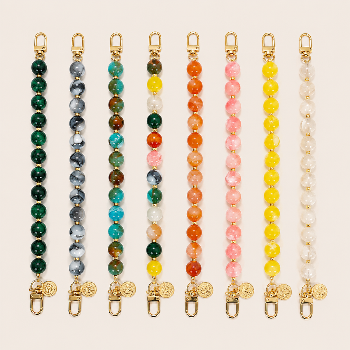 Eight Sable PHONE CHAIN colorways in dark green, grey marble, teal, multicolor, orange, pink, and yellow beads with gold coin charms.