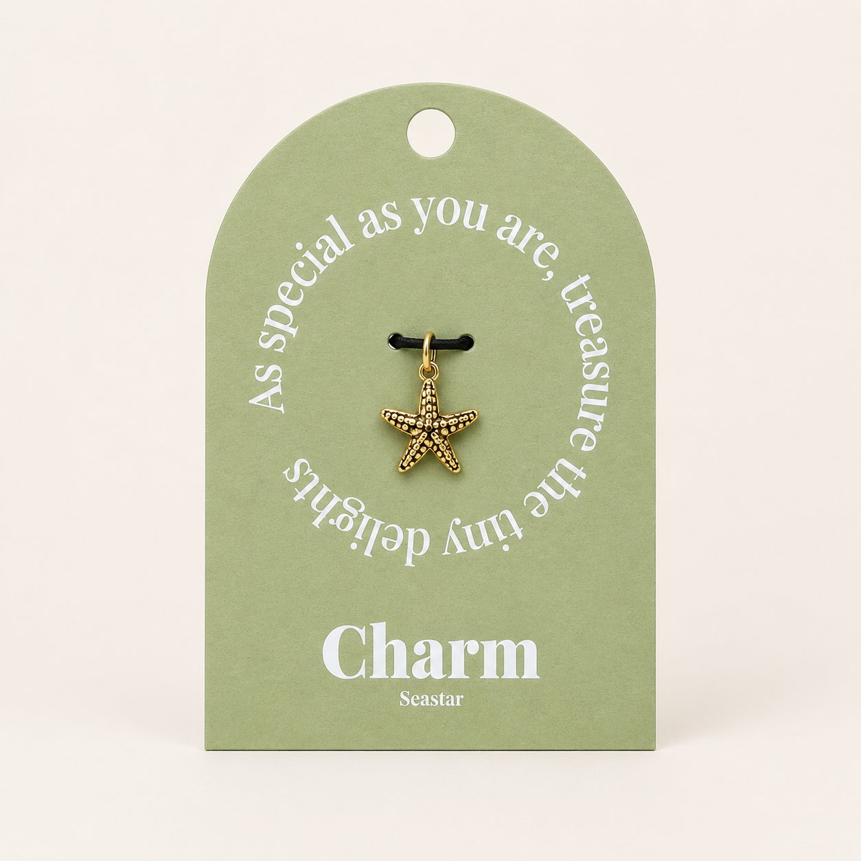 The Seastar CHARM displayed on a sage green Charm gift tag, hanging from a black cord against the card text As special as you are.